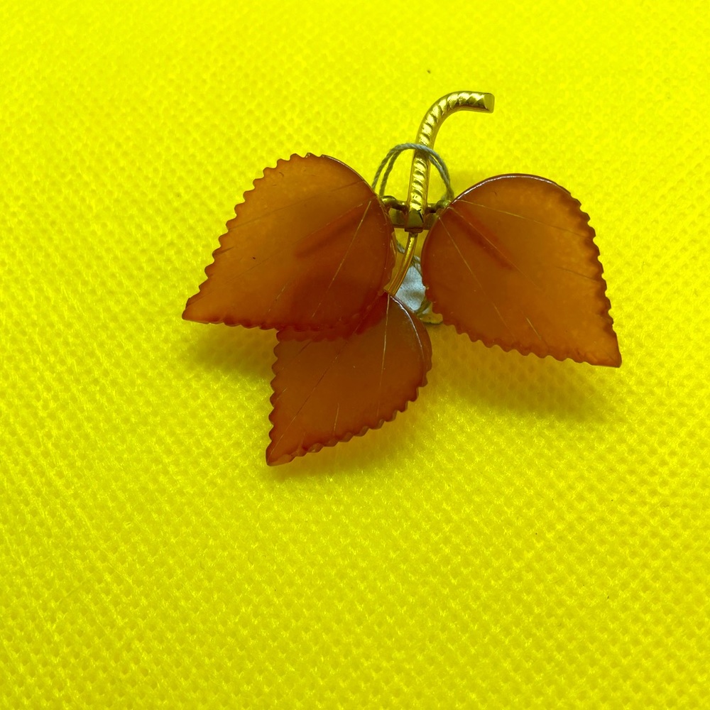 An amber (faux) gold plated three leaf brooch.